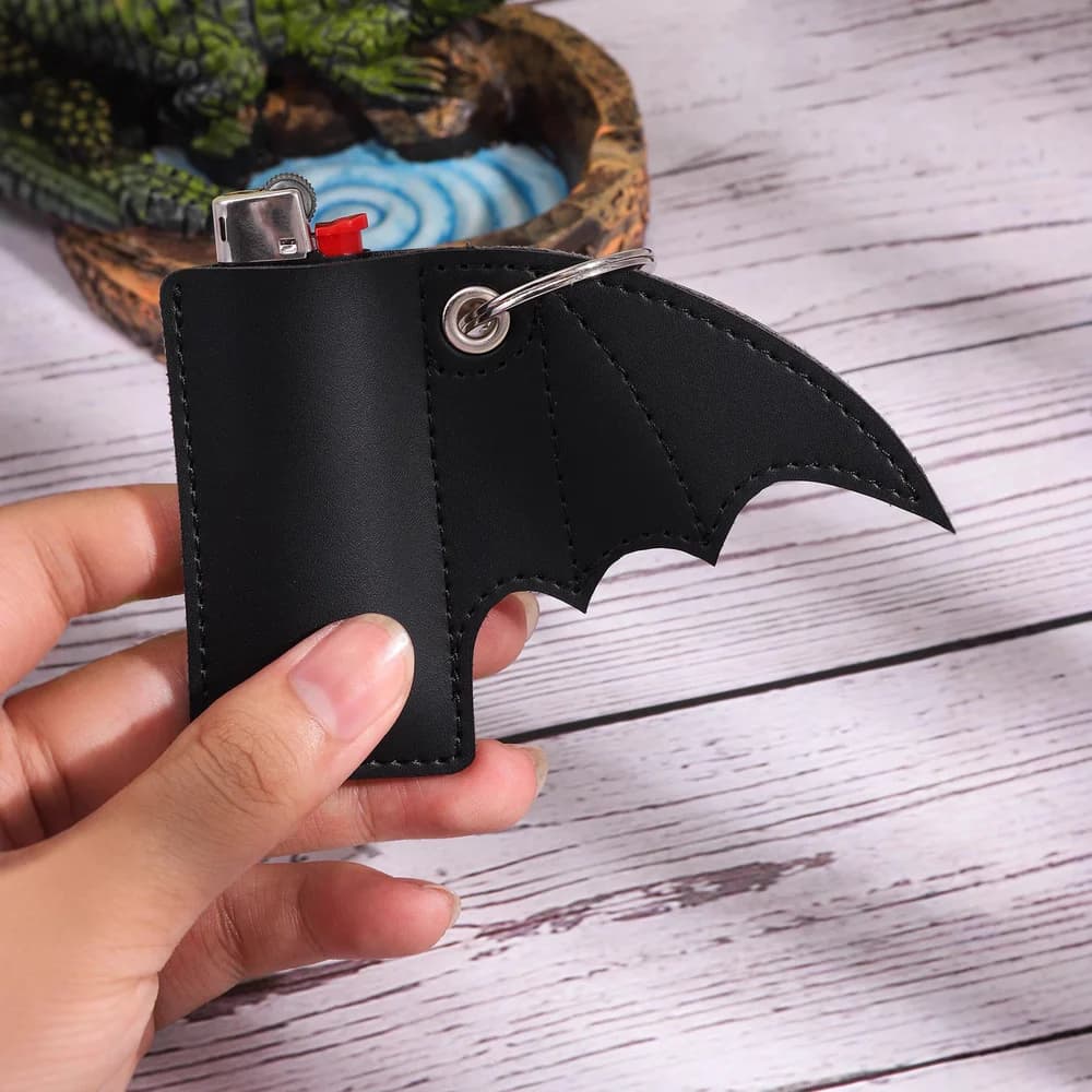 Black bat-shaped PU lighter holder shown in hand