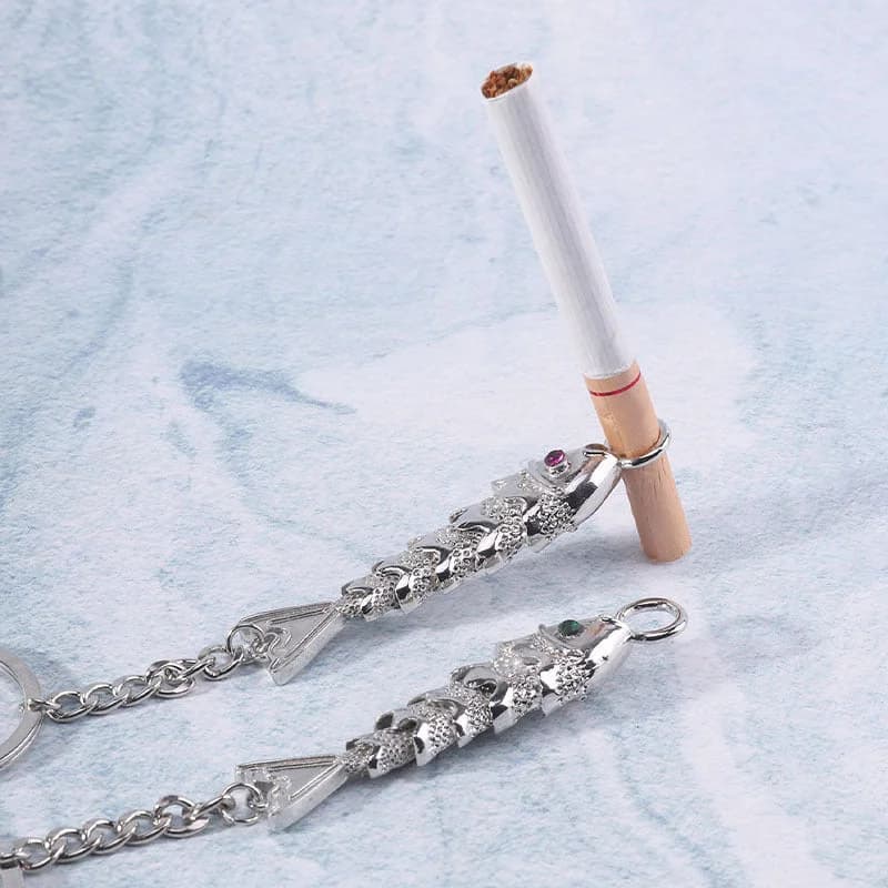 Two silver fish-shaped cigarette holder keychains