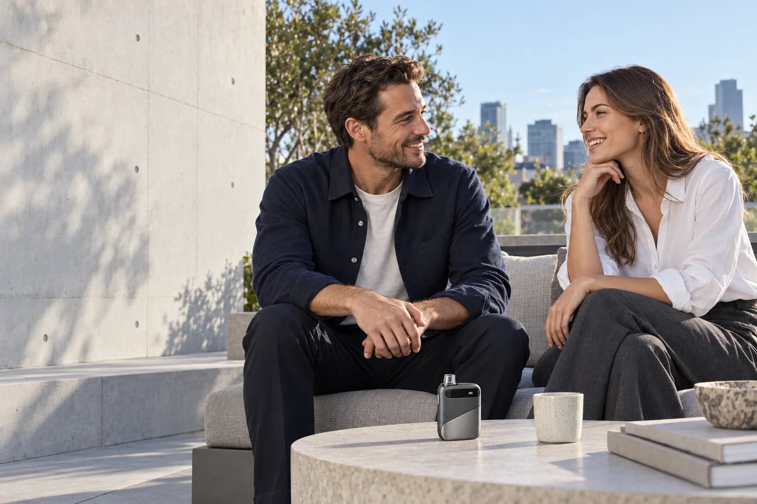 Two adults in contemporary casual clothing talking on a sunlit terrace, with the ARC concept on a table