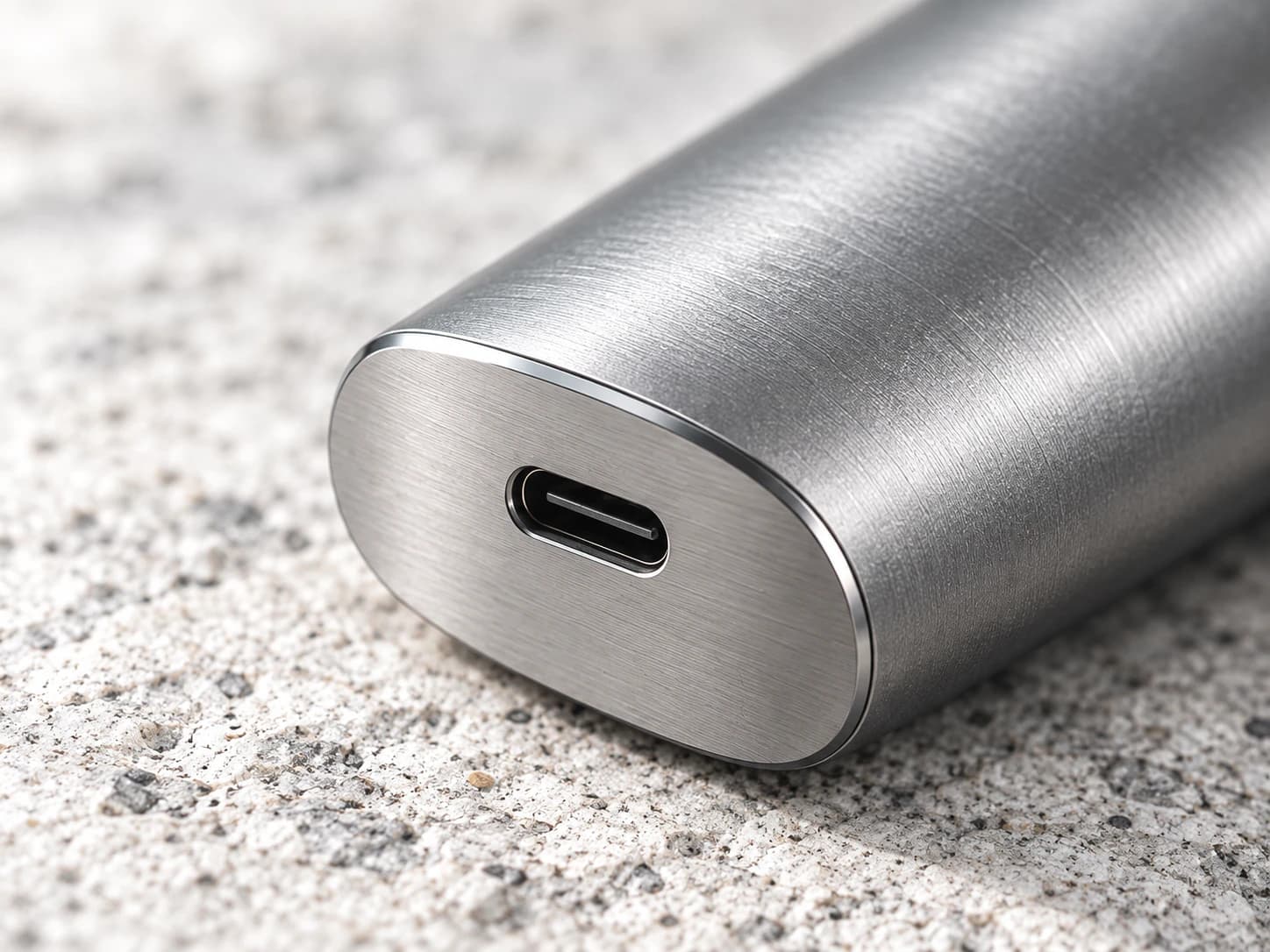 Exterior concept study of a brushed-metal hardware enclosure and charging opening.